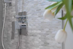 Lunada Bay Agate Martini in Cortona Pearl. Glass tile with elongated hexagon shape.